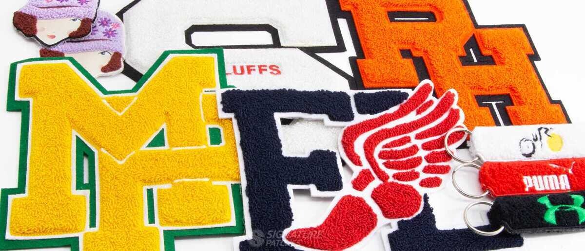 Collection of chenille varsity letter patches and keychains in various colors